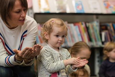 Parent and child doing actions together to a song or rhyme at a Bookbug Session